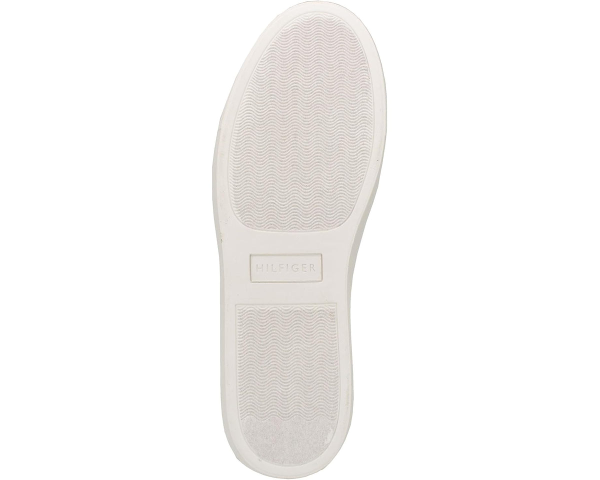 Light outsole bottom of grey sneakers with textured tread and logo