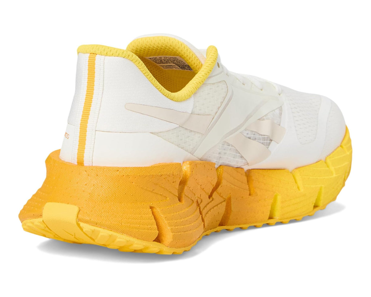 Men's white and yellow running sneaker with padded collar and grippy outsole