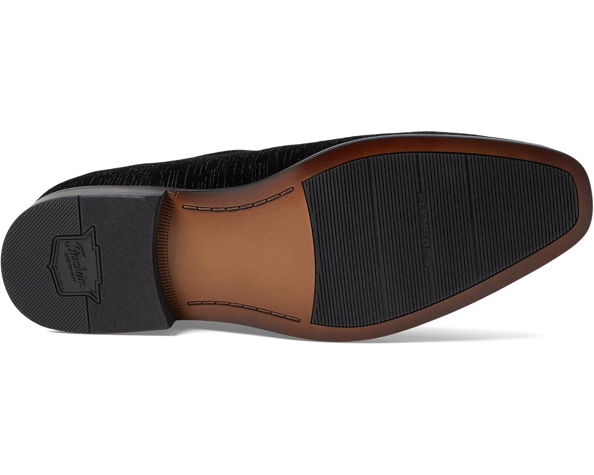 Black velvet slip-on loafer bottom view with textured rubber sole