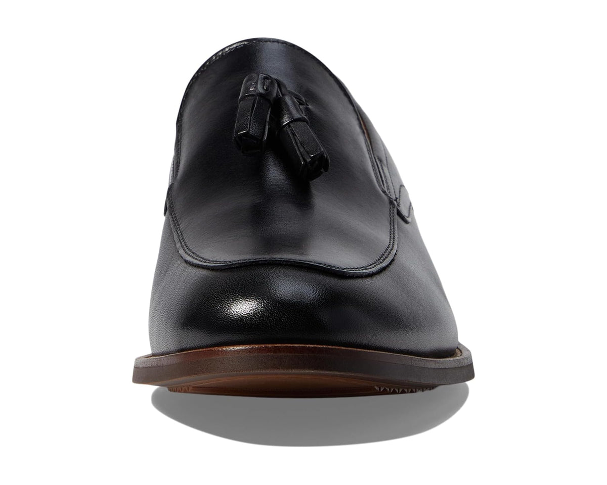 Men's black moc-toe loafer front with tassel-like ornament and brown sole