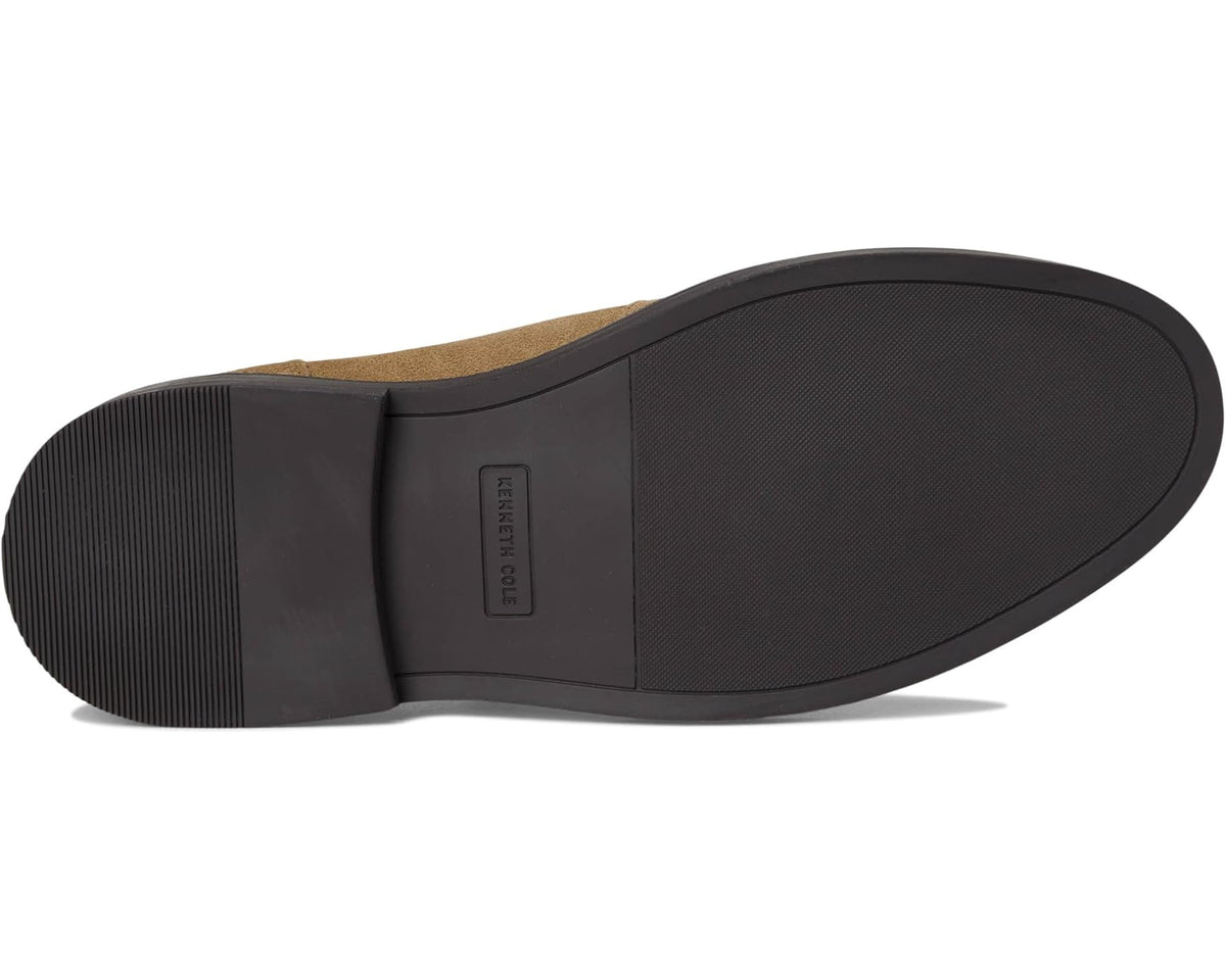 Tan suede shoe outsole with textured black rubber tread