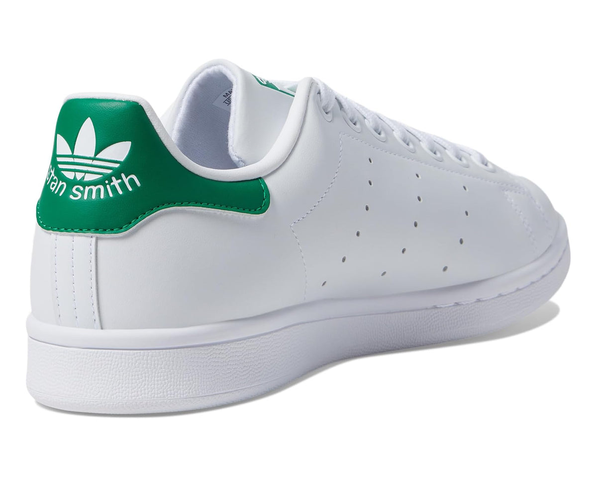 White leather sneakers with green heel lining and 'Stan Smith' logo text