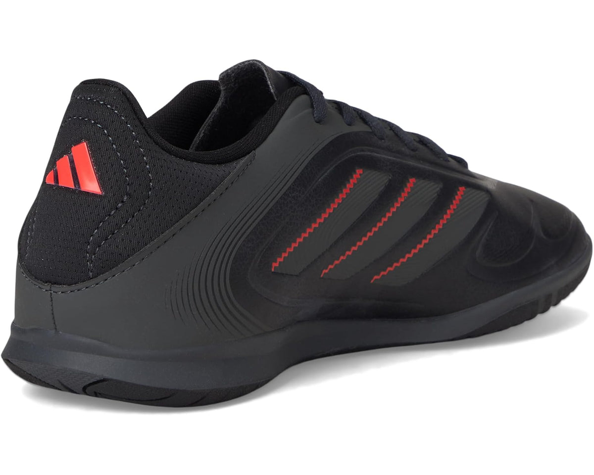 Black adidas indoor soccer shoes, heel and logo detail with red accent stripes
