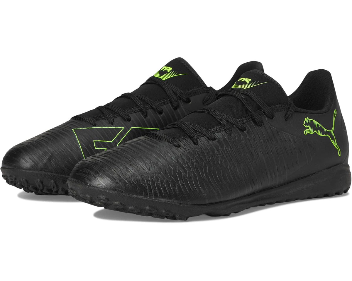Men's PUMA turf trainer cleats in black with neon green logo and lace-up design