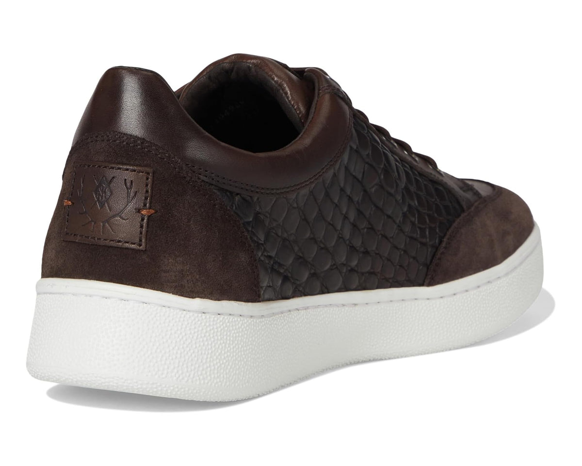 Dark brown leather sneaker heel with embossed pattern and stitched logo patch