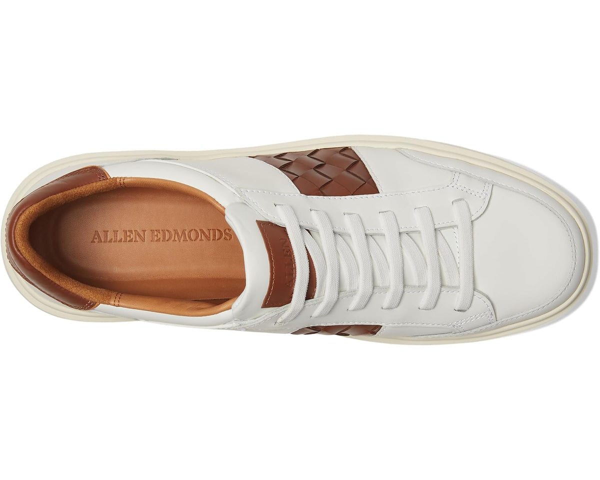 White leather sneaker with tan interior, lace area, and woven brown panel detail