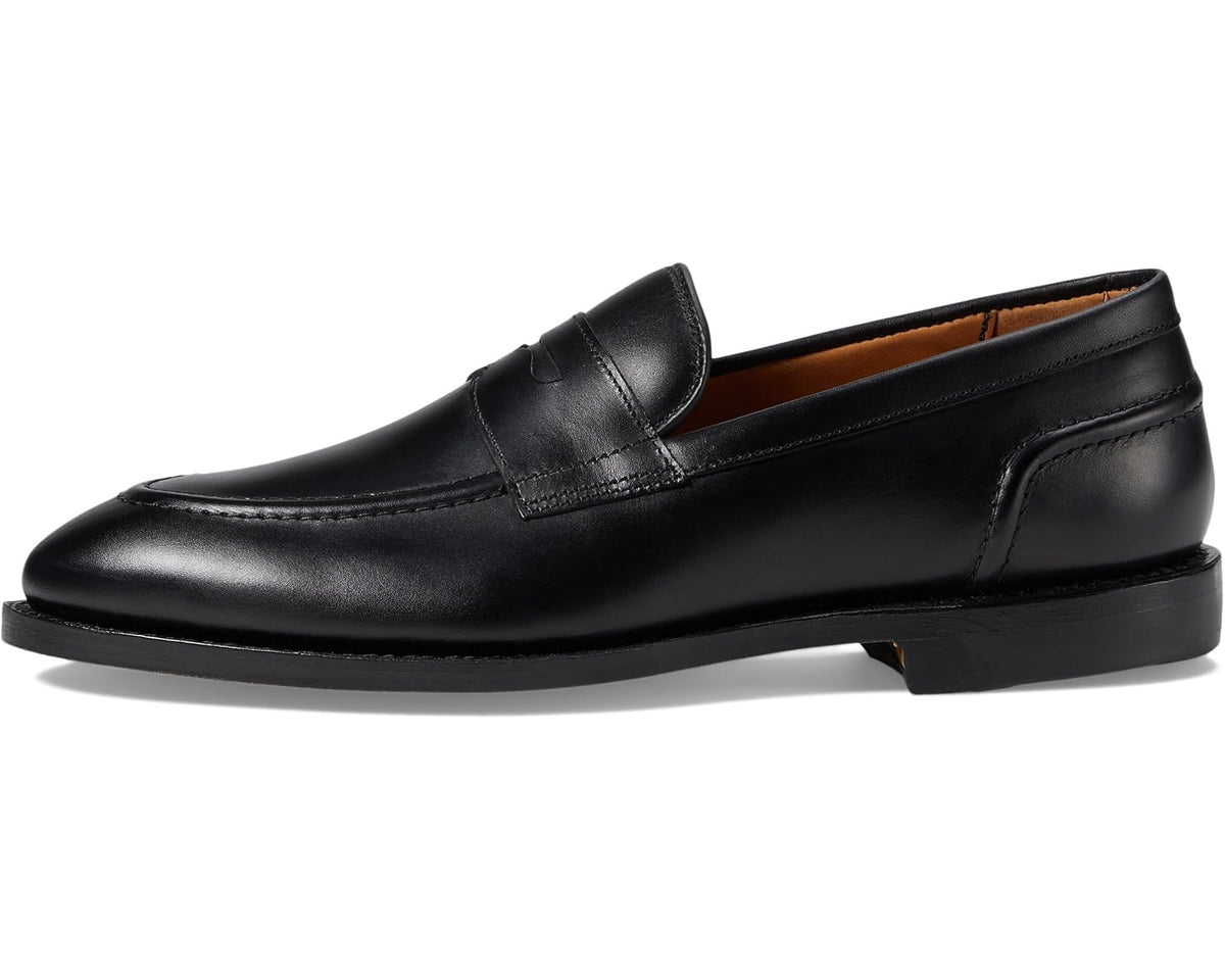 Black leather penny loafer with low heel and slip-on design