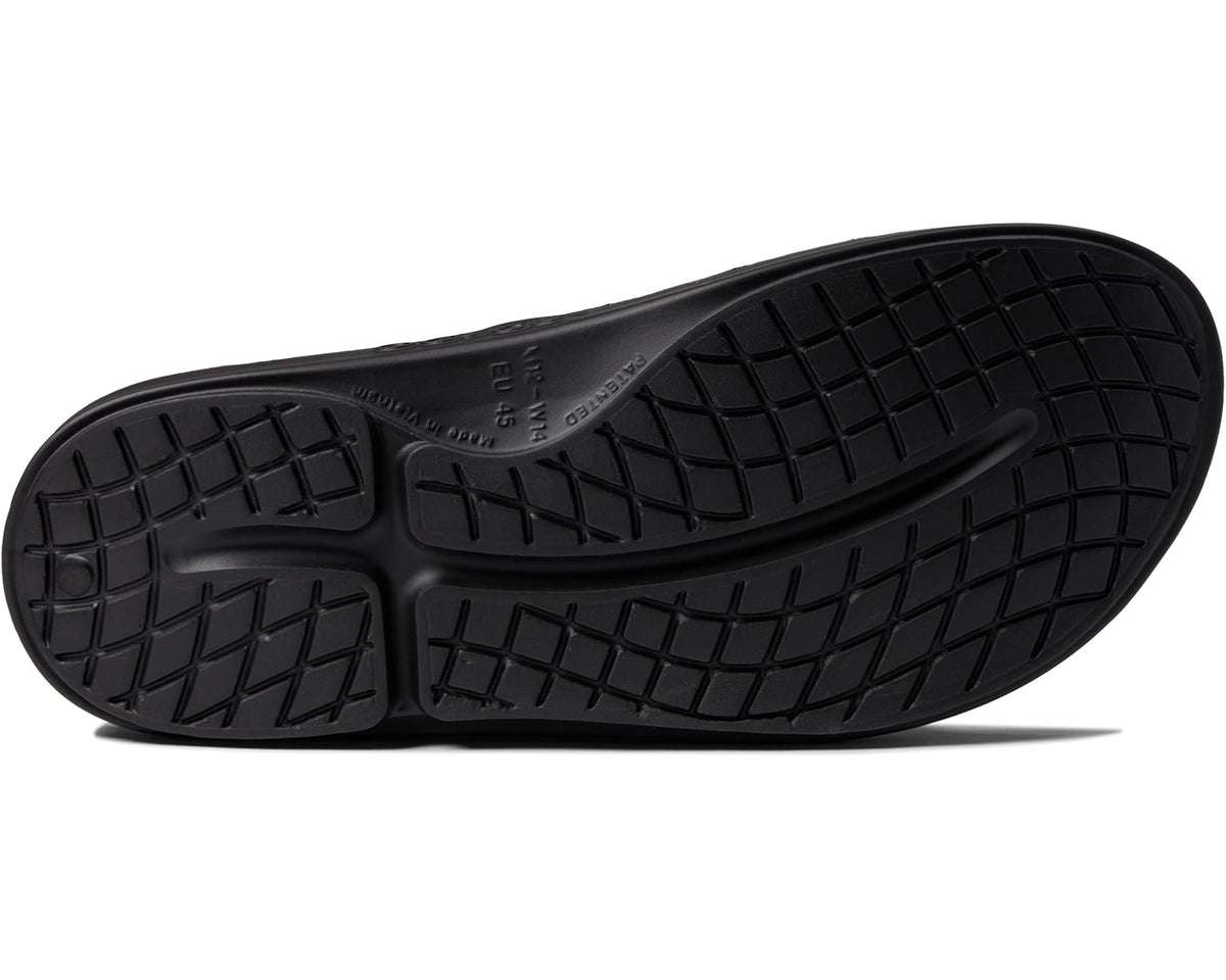 Black OOahh slide sandal outsole with grid-like tread pattern