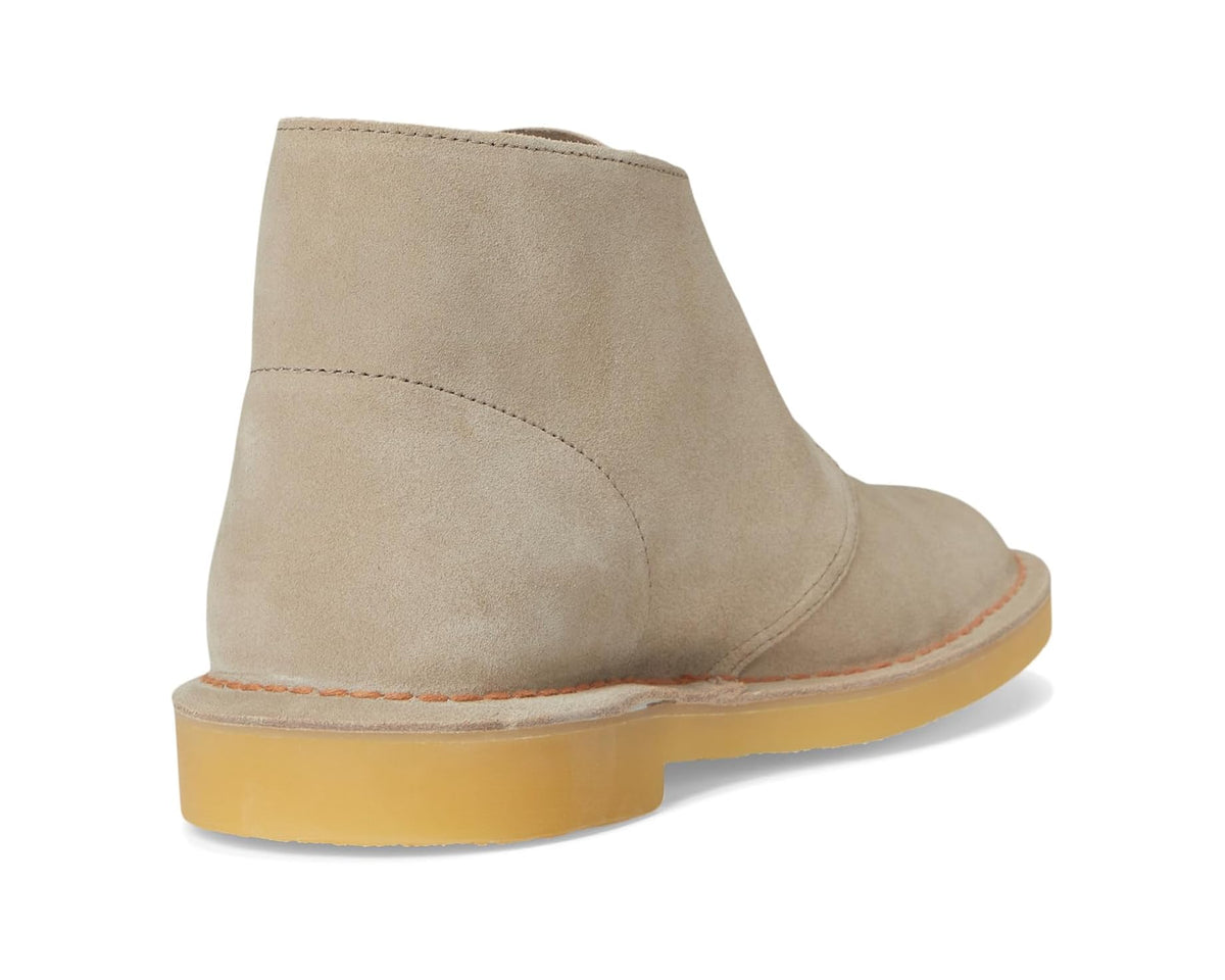 Sand suede chukka boot heel with side seam and chunky yellow sole.