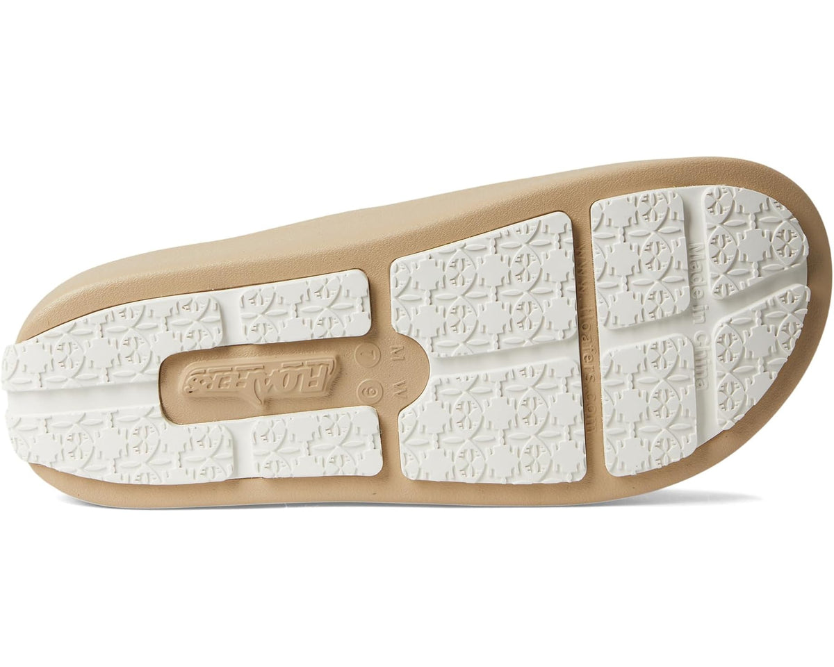 Warm sand slide sandal outsole with white textured traction and logo