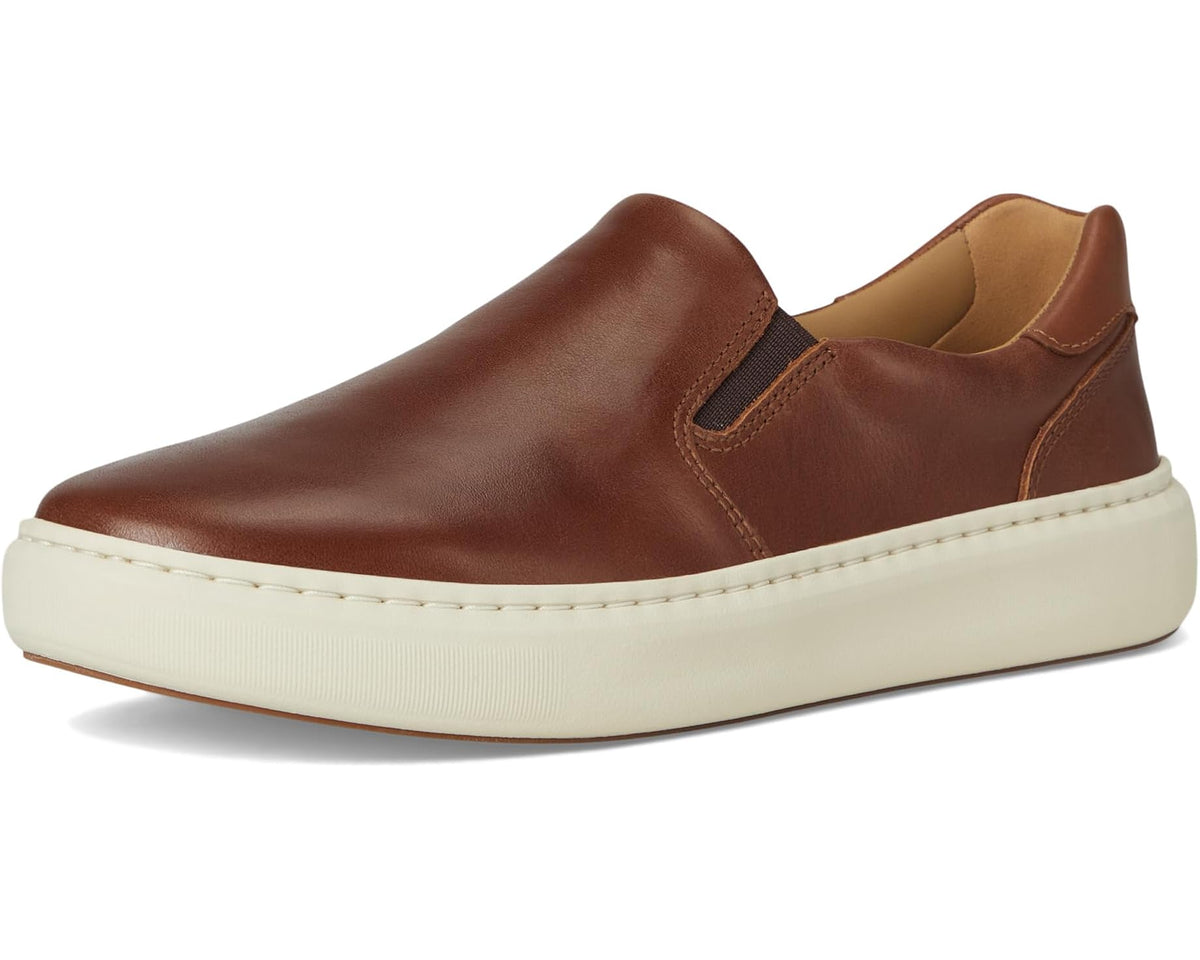 Side view of tan-brown slip-on leather sneaker with low profile sole