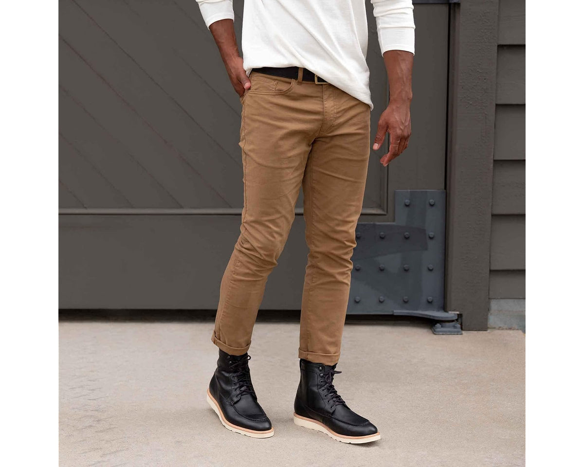 Men wearing black lace-up boots with tan-cream rubber sole and toe cap