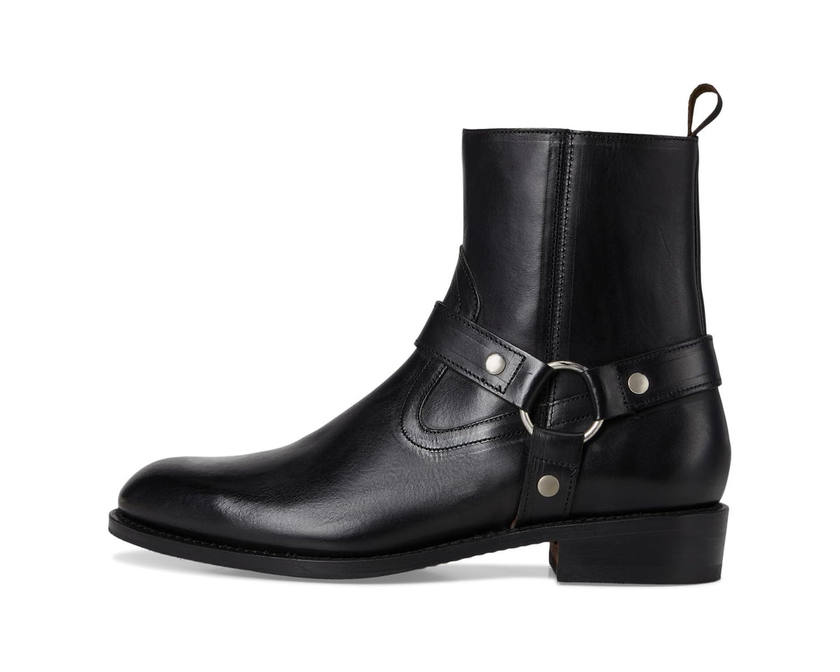 Black ankle boot with buckle strap across the instep and pull tab at top