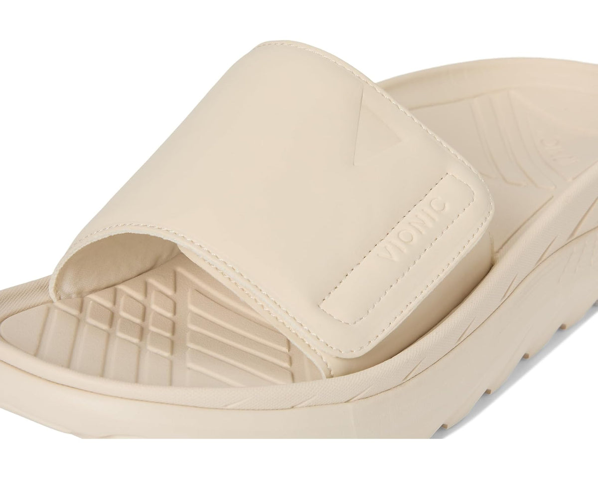 Cream slide sandal close-up of wide strap and VIONIC logo