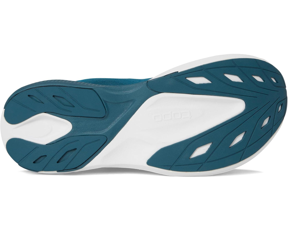 Blue and white shoe outsole with traction pods and white midsole