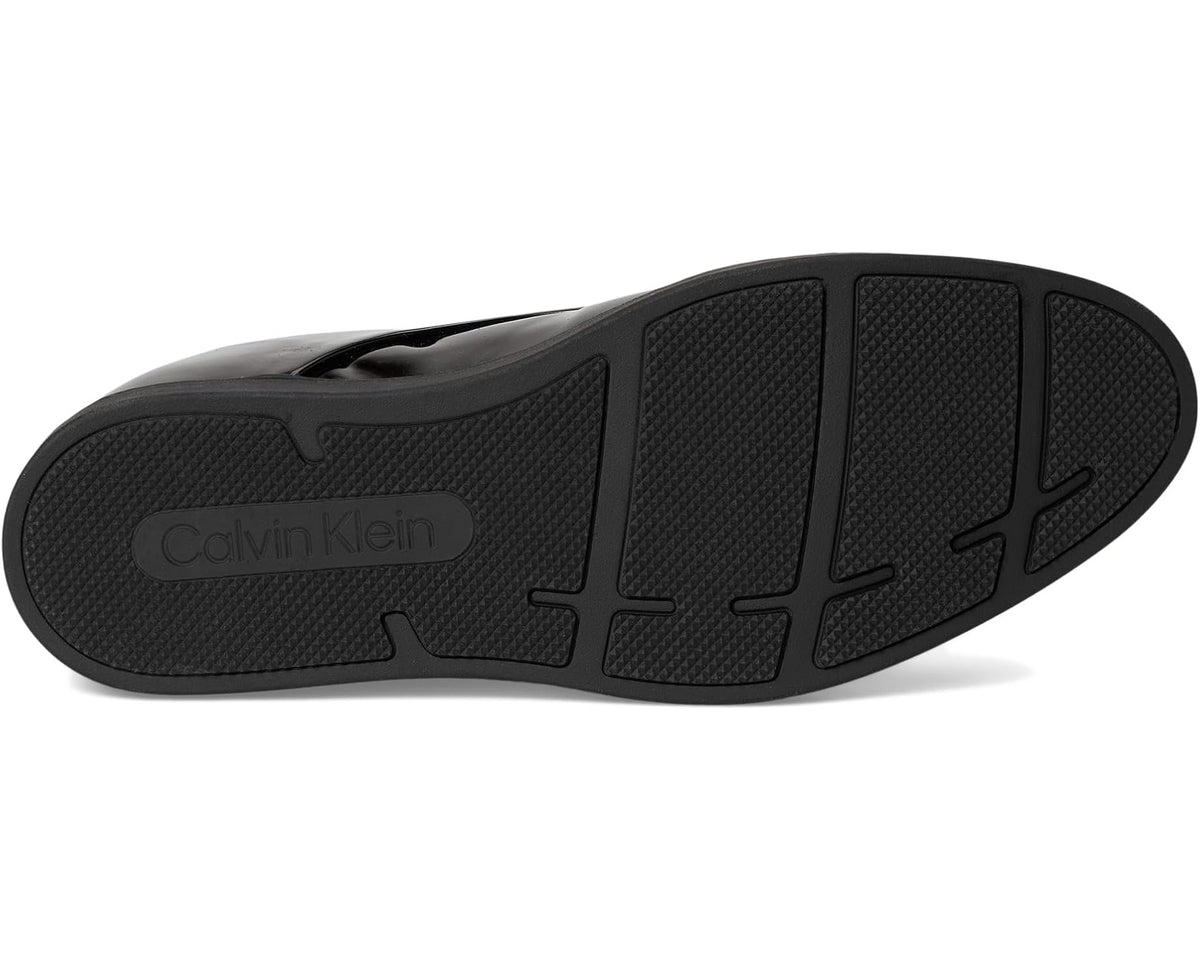 Black patent leather rubber outsole with Calvin Klein logo and tread