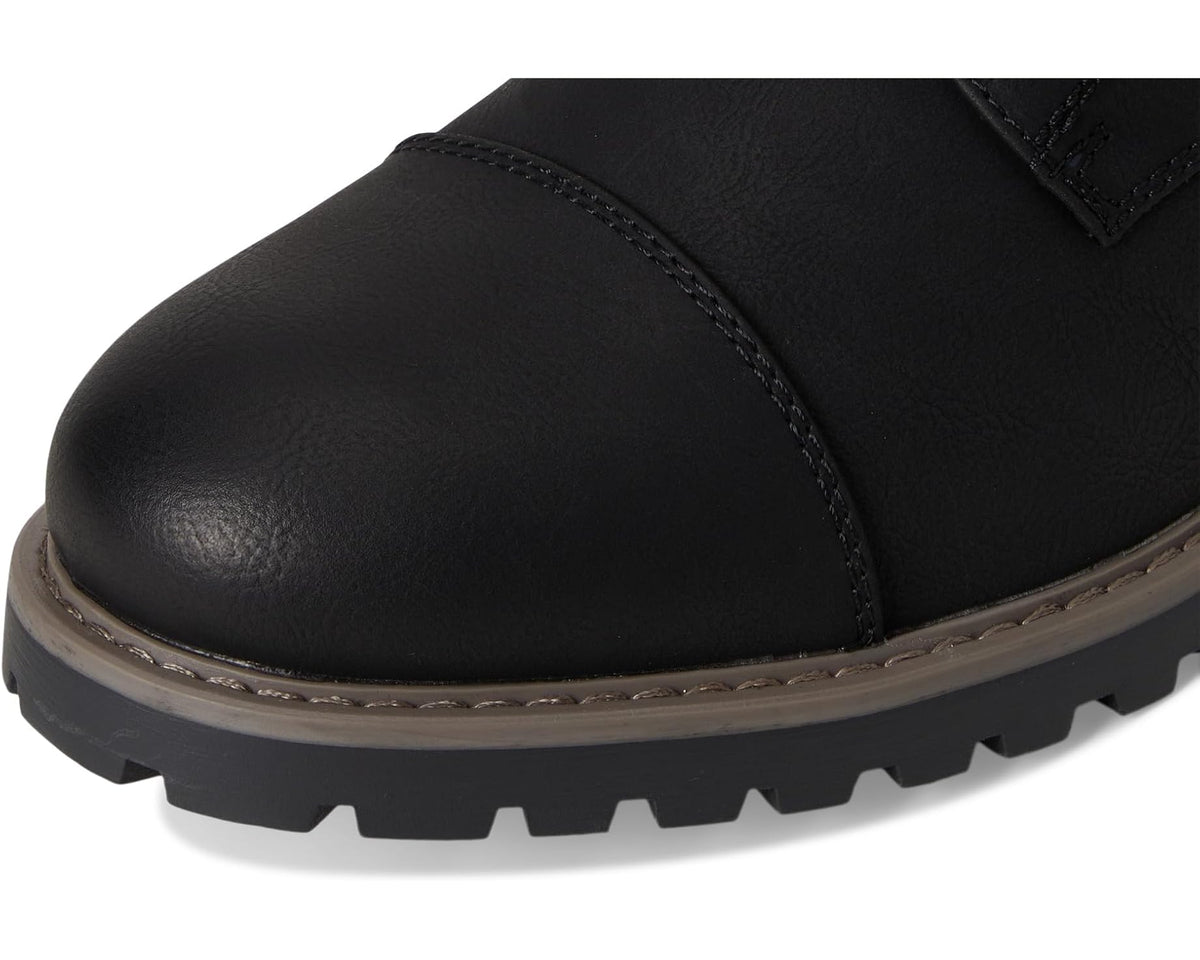 Black boot toe with stitched edge, smooth leather-look upper, and gray-brown outsole trim