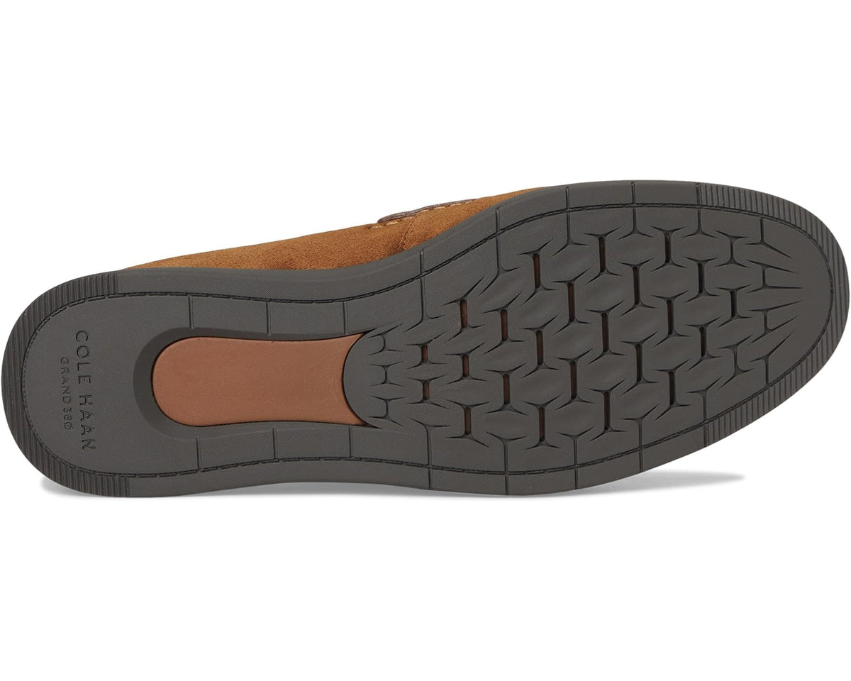 Men's brown suede penny loafer outsole with textured rubber tread