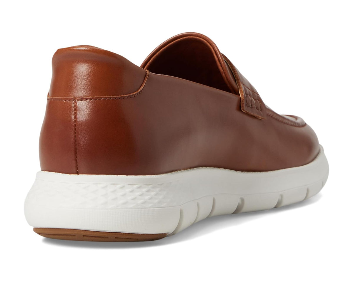 Cognac leather slip-on loafer with cushioned heel collar and white rubber sole