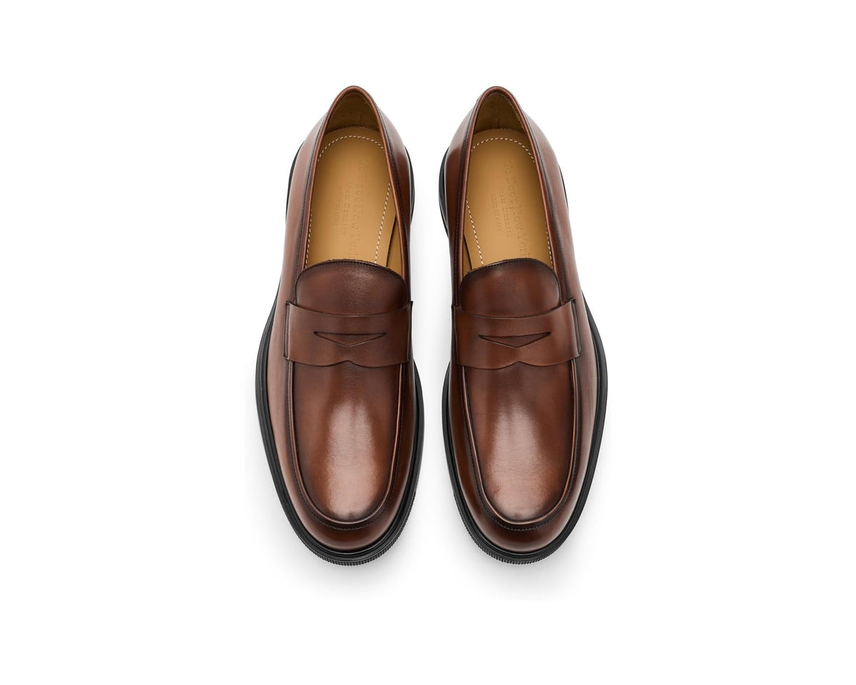 Pair of brown leather penny loafers with moc-toe stitching and black soles