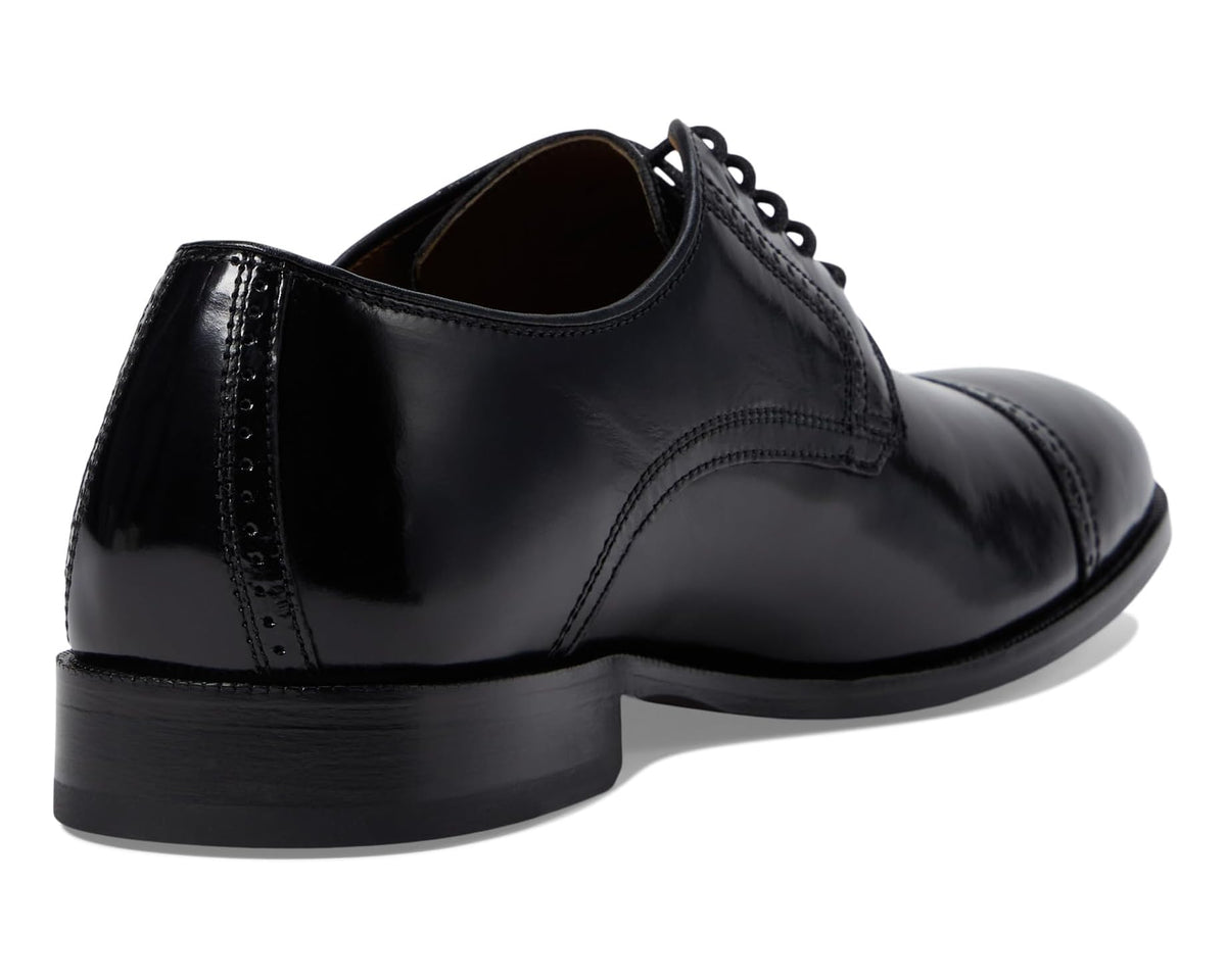 Black Oxford dress shoe with lace-up top and smooth heel counter, rear view
