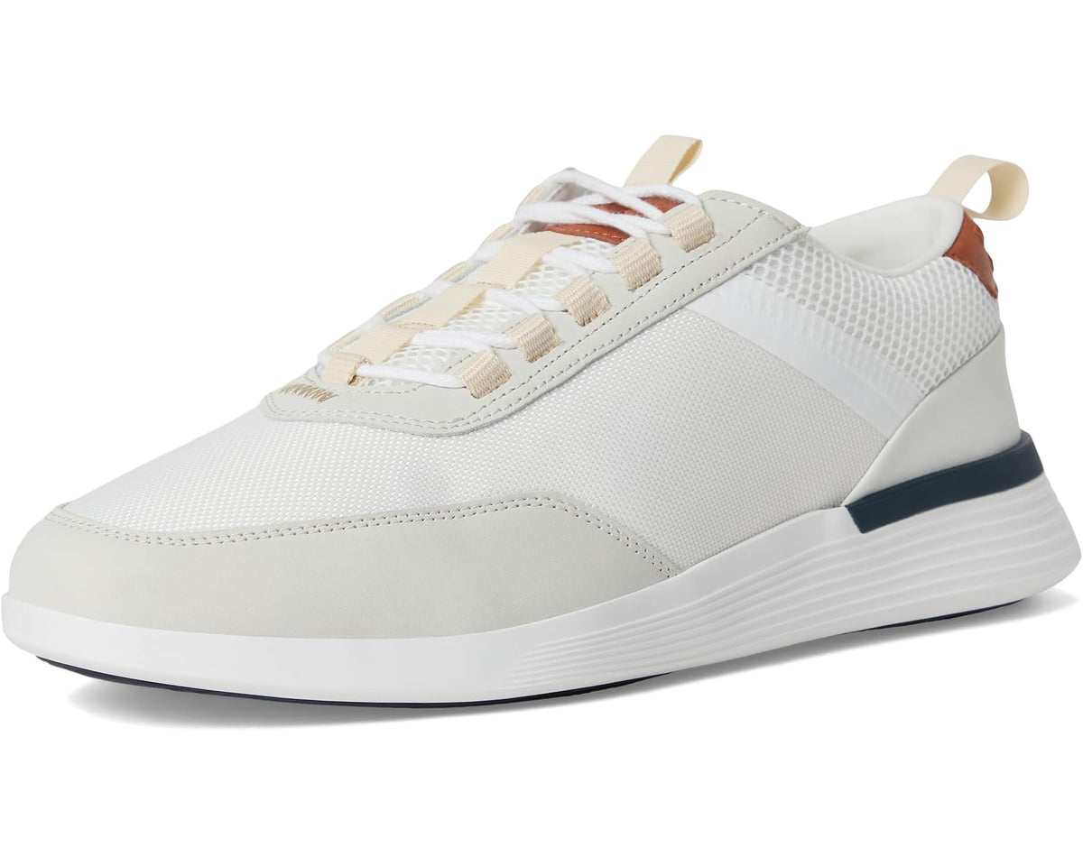 White low-top crossover sneakers with lace-up closure and navy heel stripe