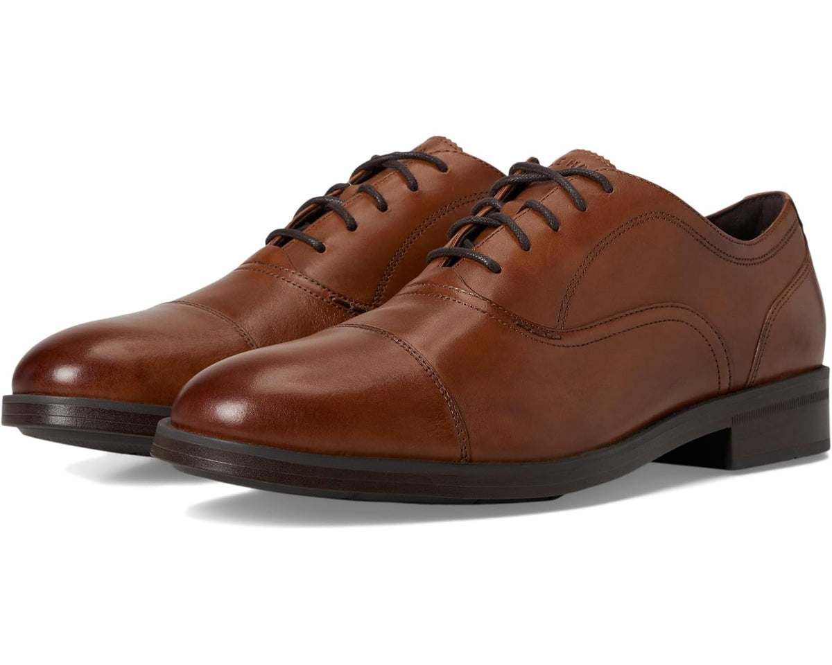 Men's leather cap-toe oxford shoes, dark brown with tan panels, lace-up.