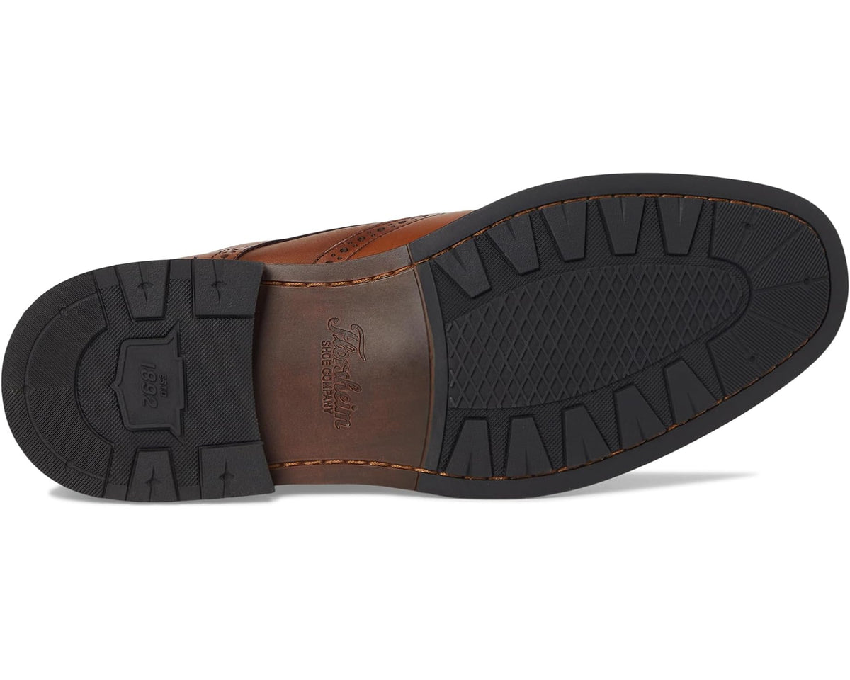 Men's wingtip oxford shoe outsole with textured rubber tread and tan leather upper