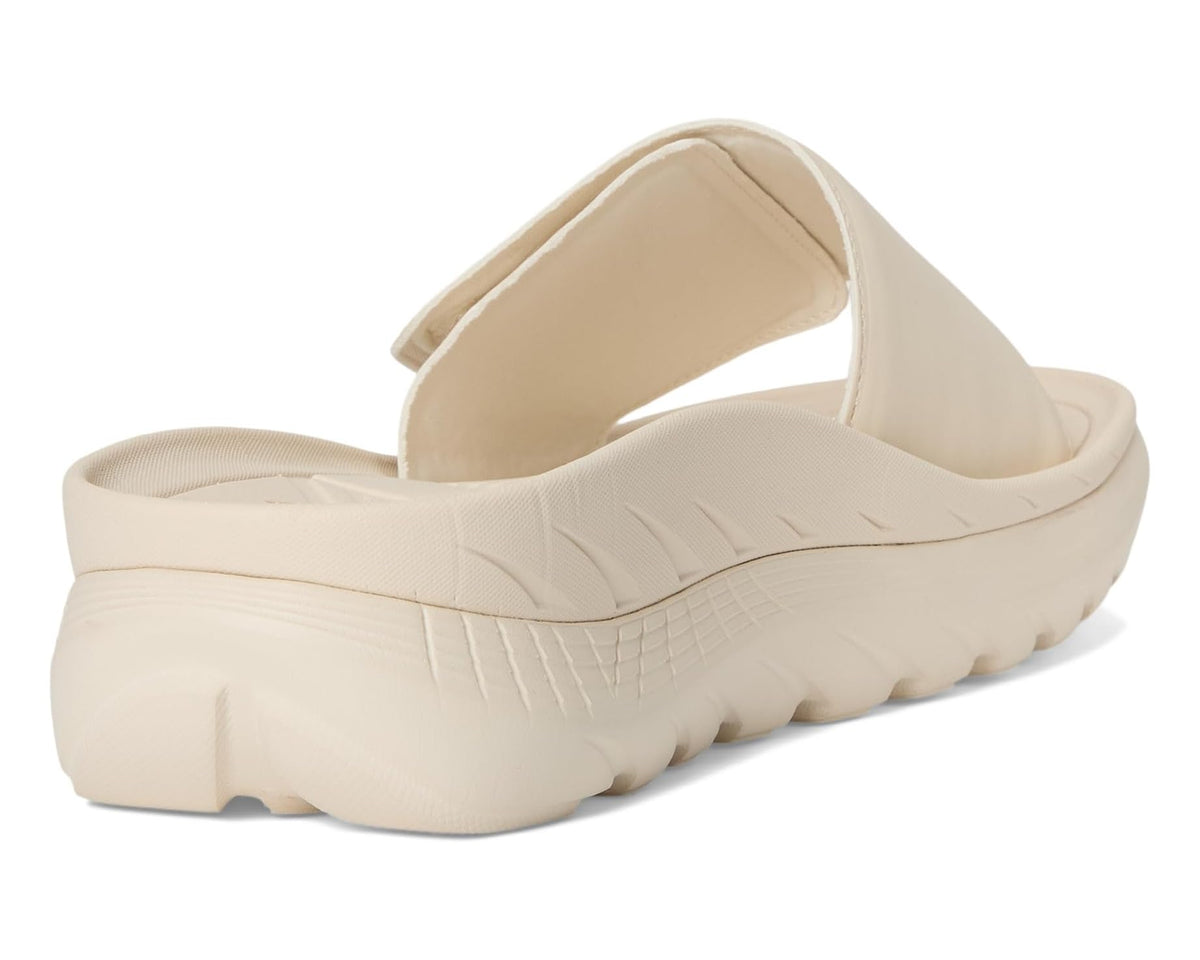 Cream slide sandal heel view with thick sculpted sole