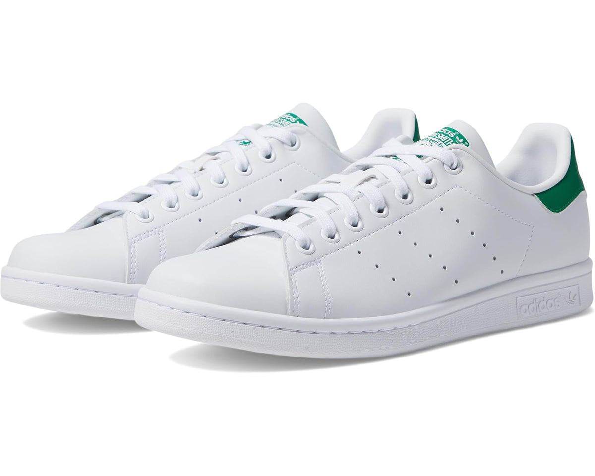 White leather low-top sneakers with green heel tab and lace-up design