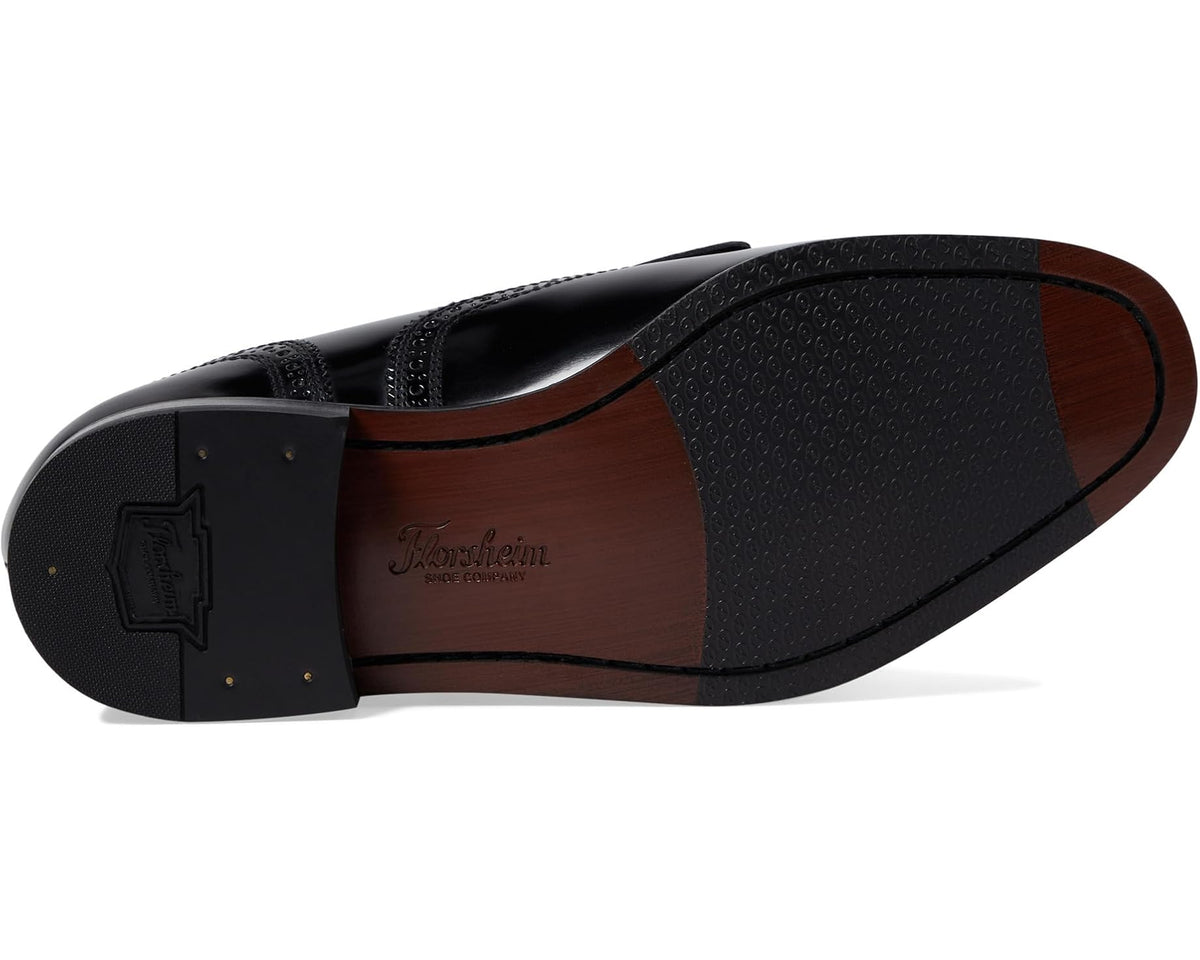 Black leather slip-on dress shoe with textured rubber sole and heel