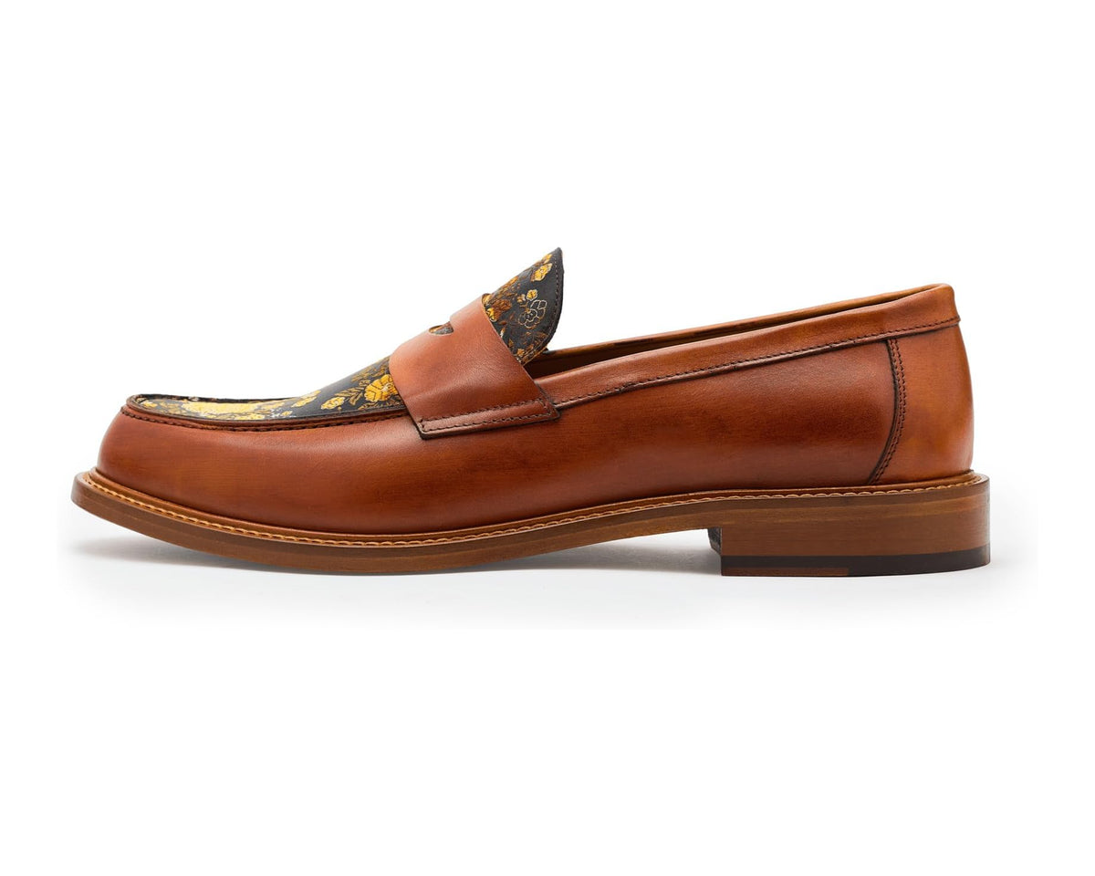 Tan leather loafer with floral-embroidered top vamp and slip-on cut