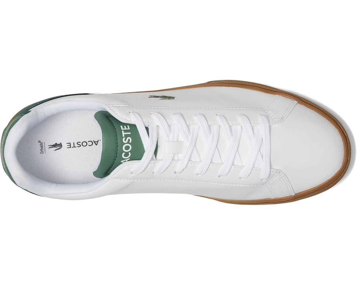 White sneaker with green lining, stitched laces, and Lacoste logo on tongue