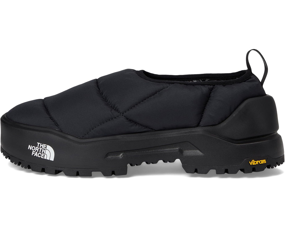Black quilted mule with padded collar, slip-on opening, and molded sole with Vibram