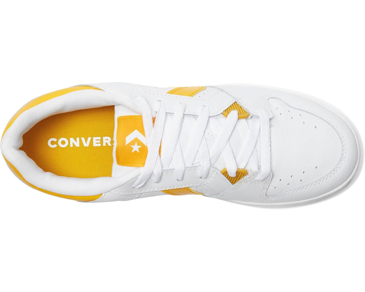 Converse sneakers viewed from side, white upper with yellow lining and laces