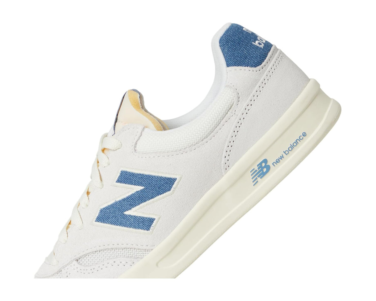 New Balance Classics 300 court sneaker diagonal view with blue side stripe and cream midsole