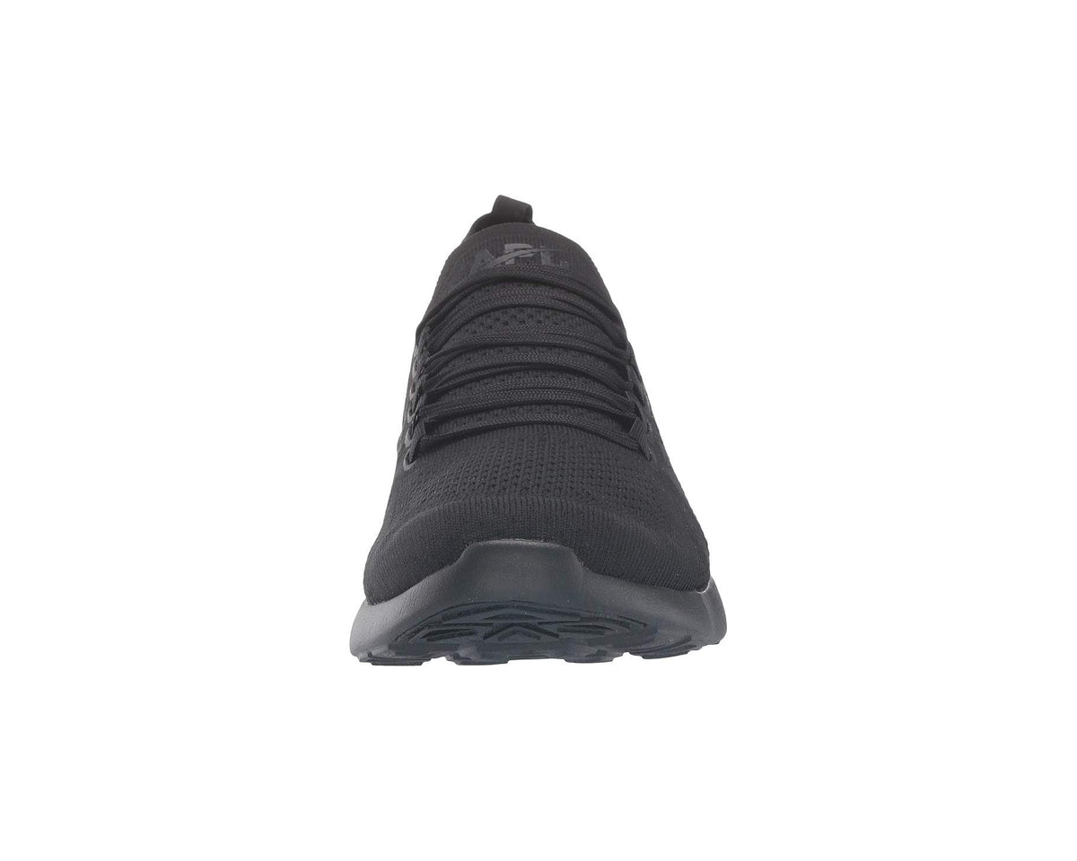 Black sneaker top-to-toe view with lace rows and low-profile rubber sole
