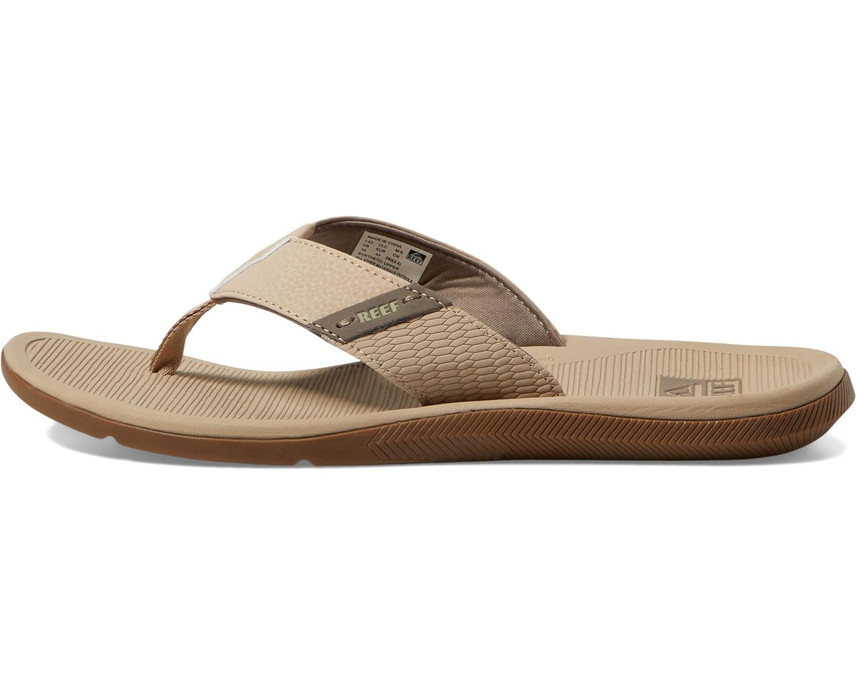 Beige thong sandals with toe strap, textured side panel, and grippy outsole