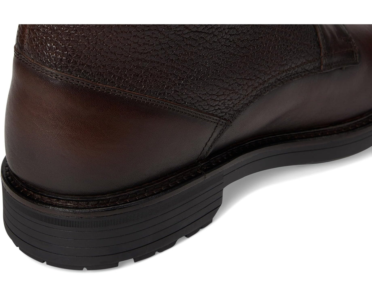 Dark brown leather boot heel with textured grain and stitched welt