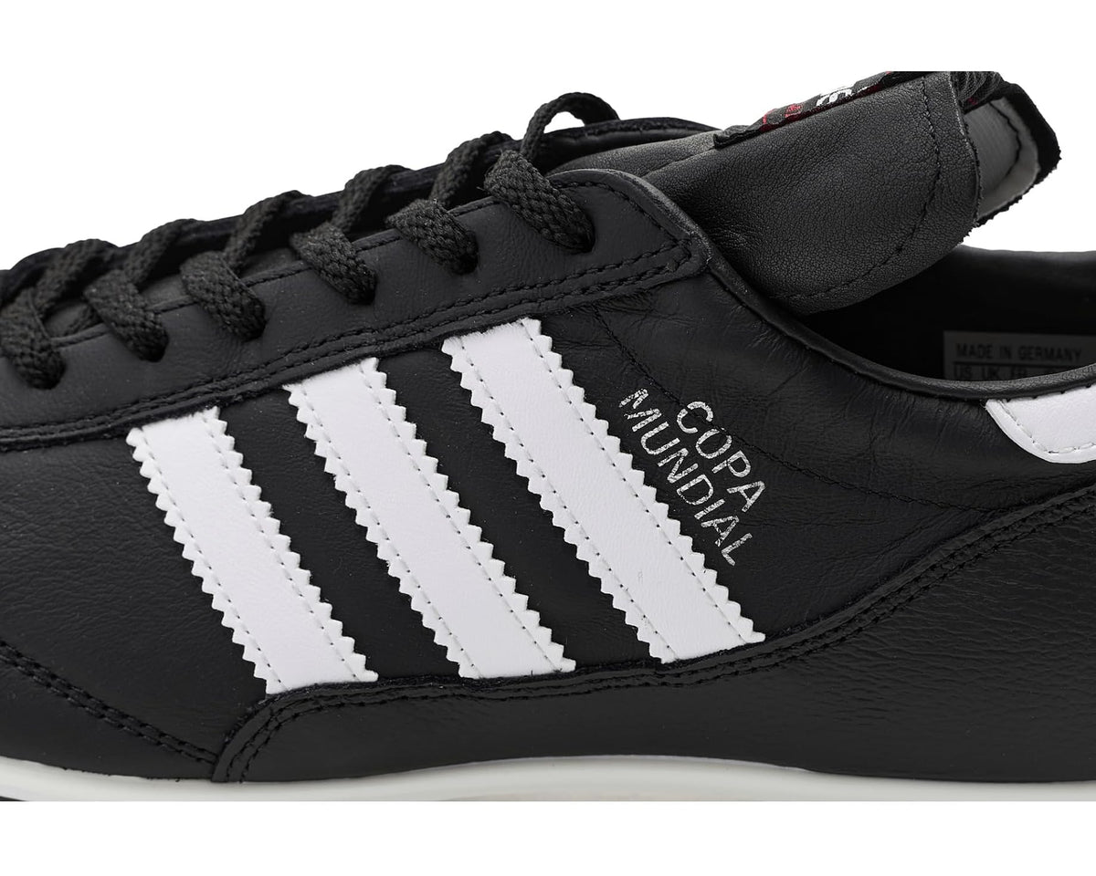 Close-up of black adidas Copa Mundial cleat with white stripes and lace-up top
