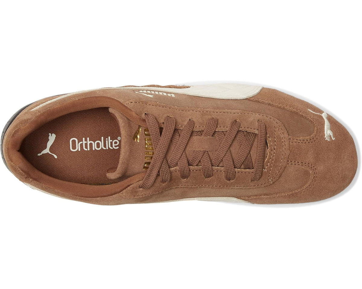 Brown and white PUMA sneakers with lace-up front and Ortholite insole branding