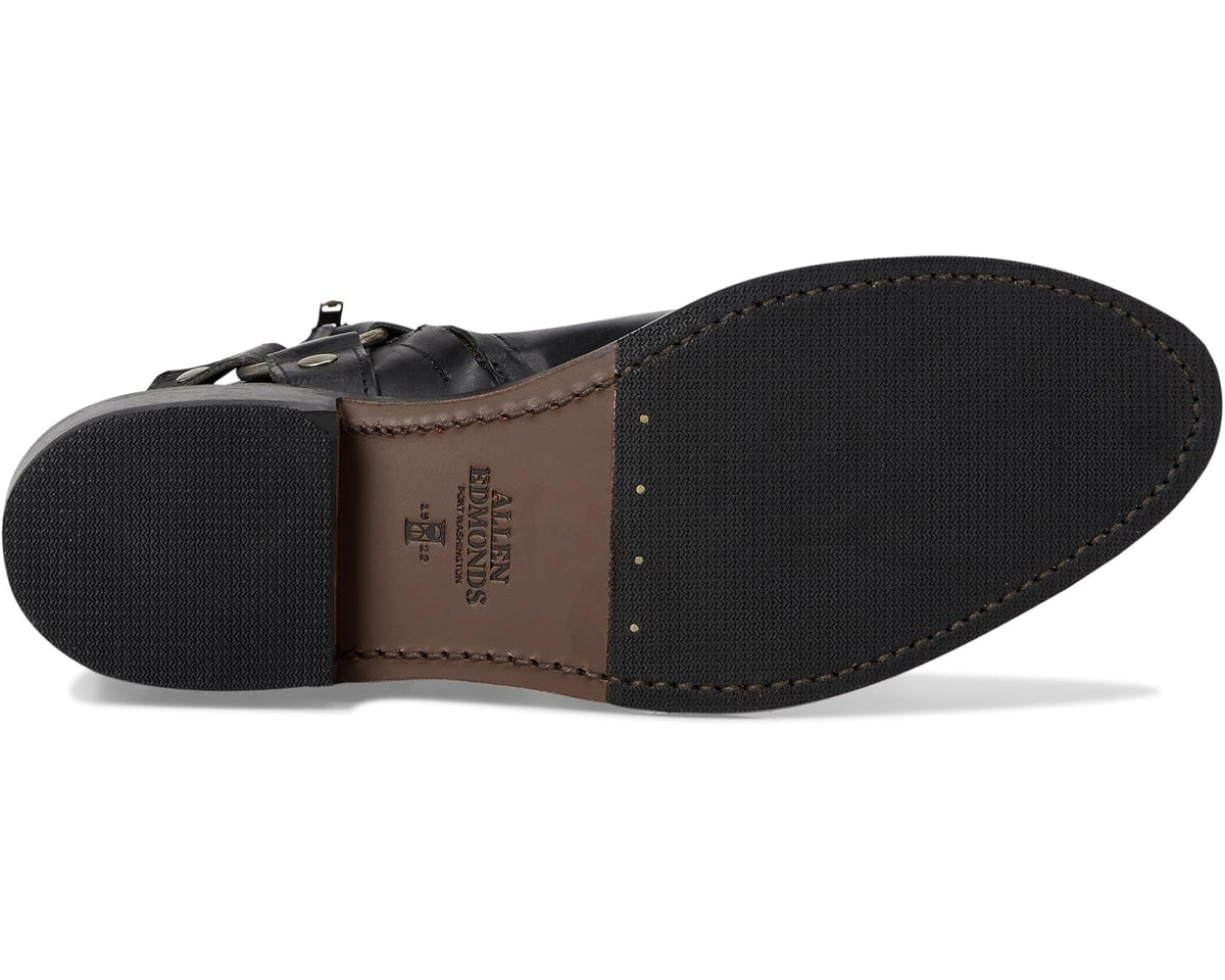 Leather sole and heel underside with stamped branding on black ankle boot