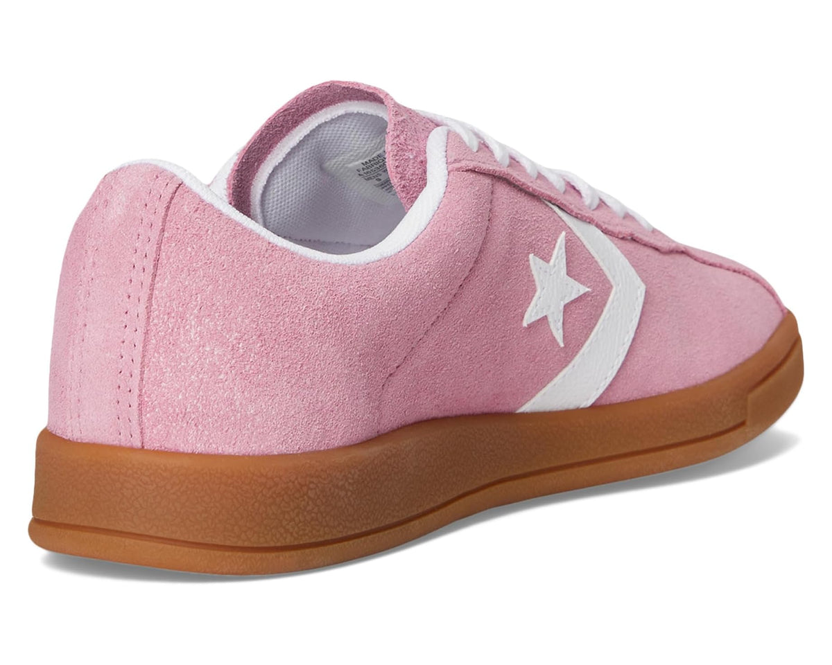 Pink suede sneaker heel with white laces, cushioned lining, and gum rubber sole