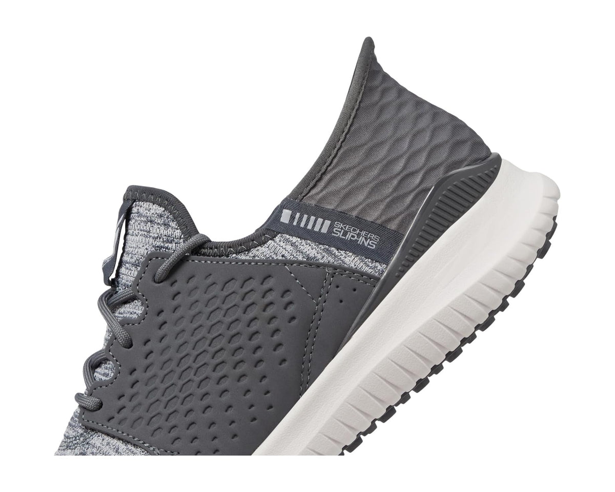 Grey slip-in golf sneaker with textured side, elastic collar, and white midsole