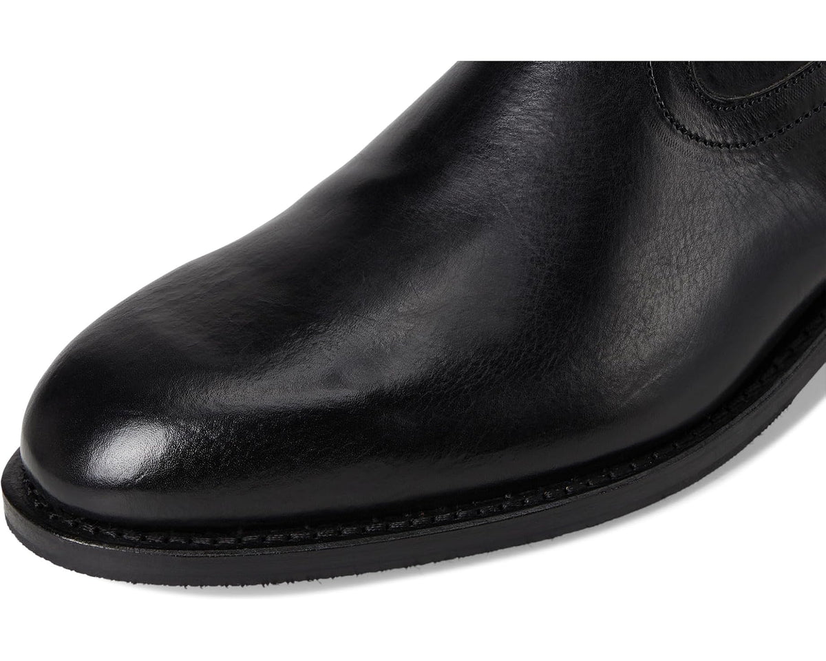 Close-up of black leather toe and stitched welt on ankle boot