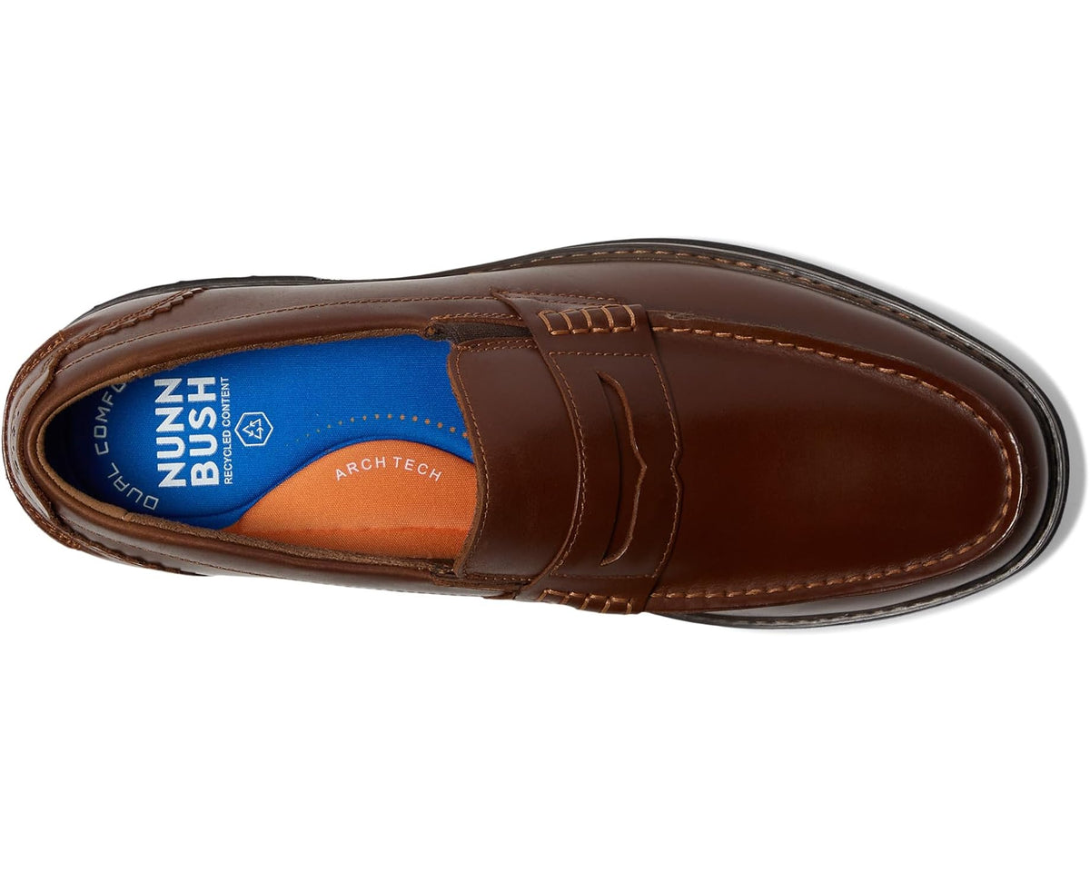 Cognac moc-toe penny loafer side profile with penny strap and edge stitching
