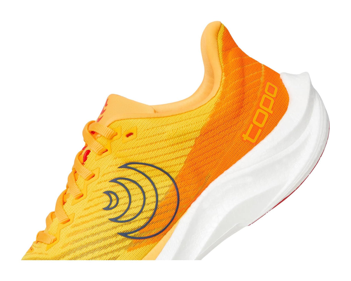 Men's running shoe upper close-up, yellow knit with orange panel and navy logo