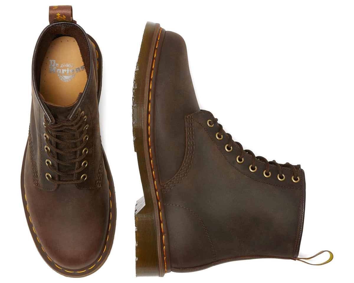 Dark brown lace-up leather boots, side view, yellow eyelets and welt stitching