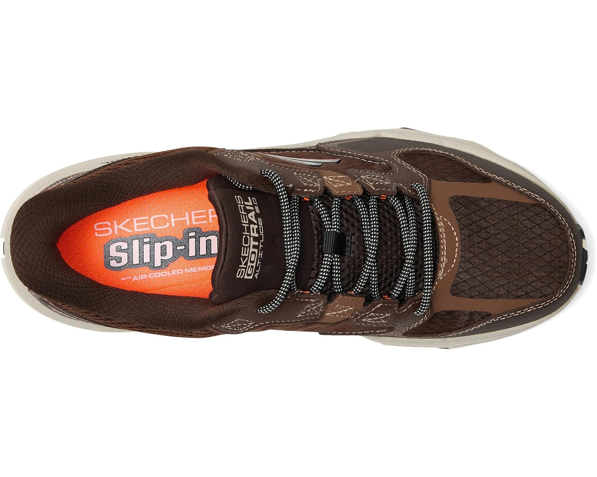 Brown slip-in sneaker with orange heel logo, mesh lining, and black lace panel