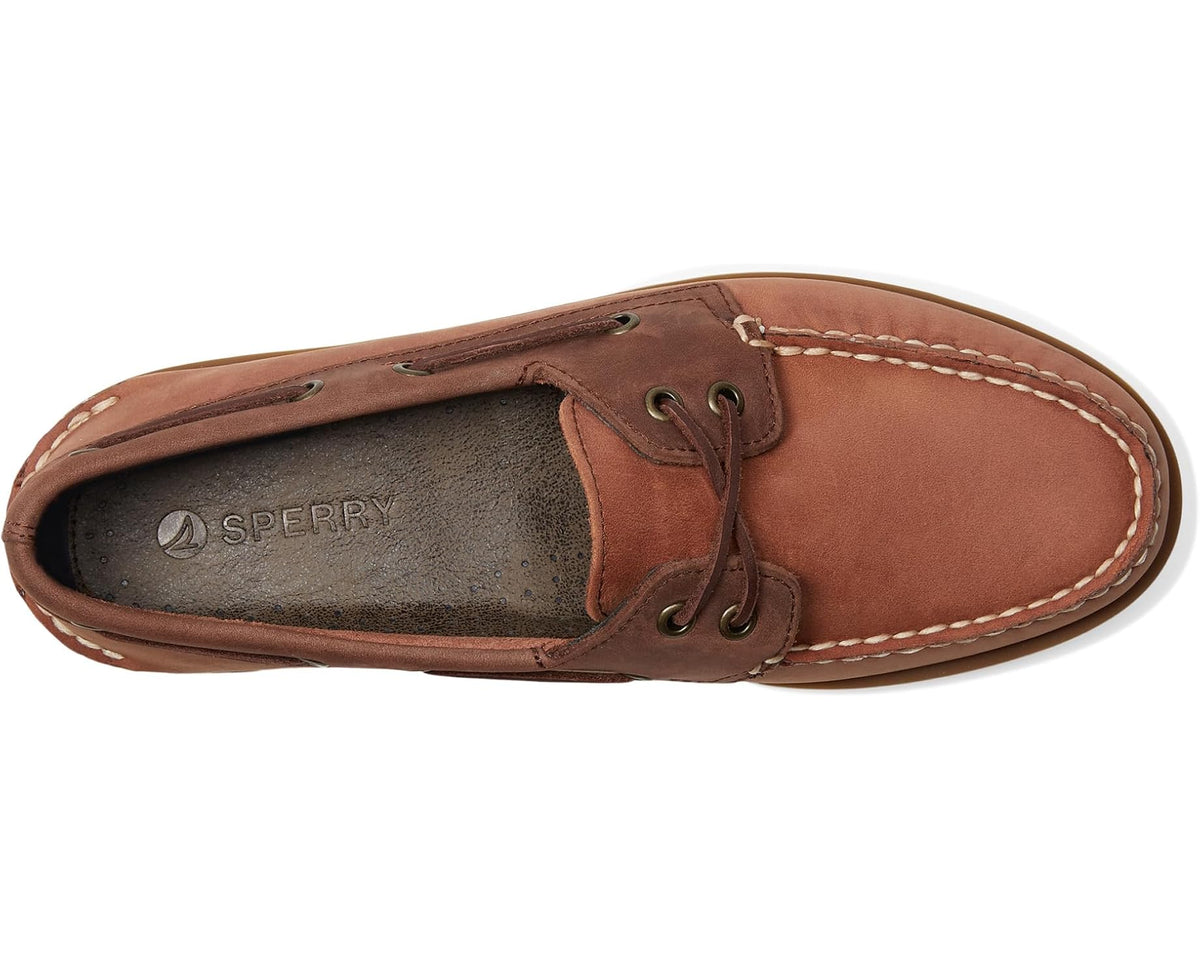 Brown two-eye boat shoe side view with lace-up eyelets and stitched moc toe
